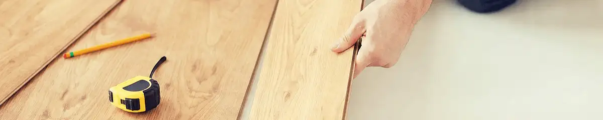 A professional installing wood flooring in San Diego, CA