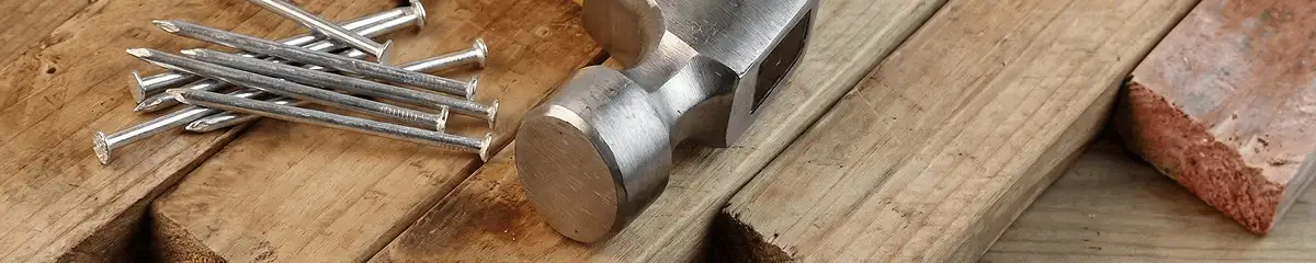 Hammer and nails on hardwood flooring boards in San Diego, CA