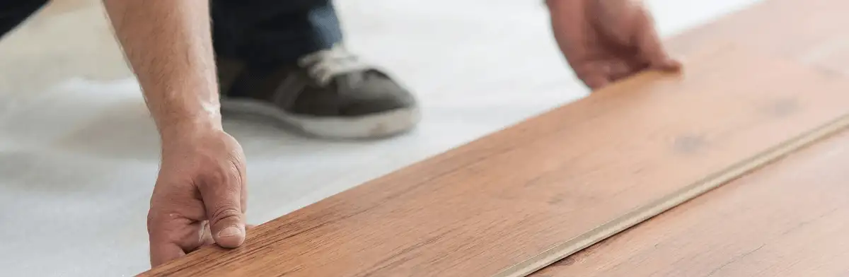A professional installing laminate flooring in San Diego, CA