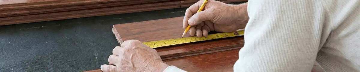 A professional installing wood flooring in San Diego, CA